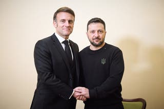 Ukraine's president Volodymyr Zelensky shakes hands with France's president Emmanuel Macron during their meeting